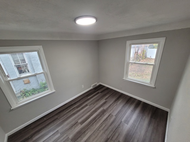 spare room featuring dark hardwood / wood-style flooring