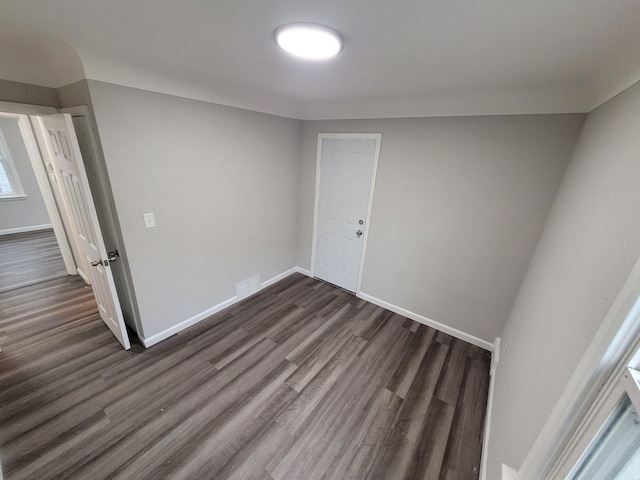 empty room with dark wood-type flooring