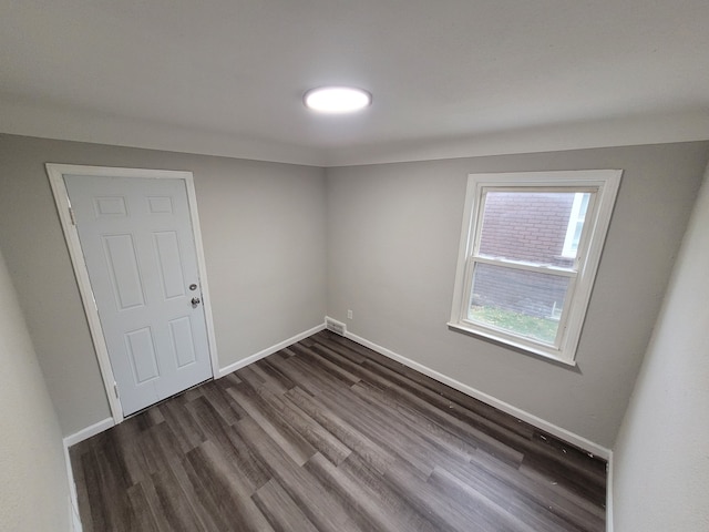 spare room with dark wood-type flooring