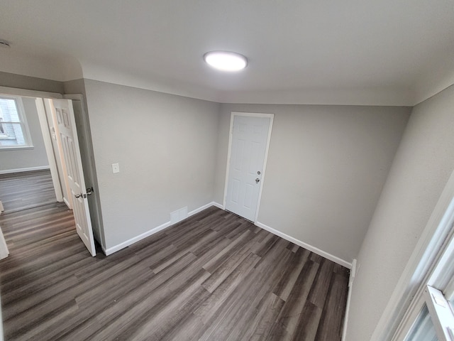 spare room with dark wood-type flooring