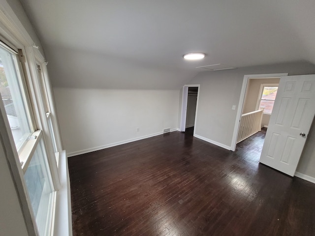 interior space with dark hardwood / wood-style floors and lofted ceiling