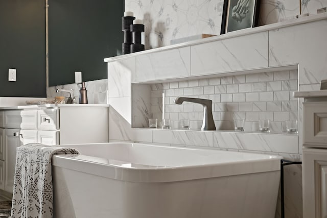 bathroom featuring tasteful backsplash and sink