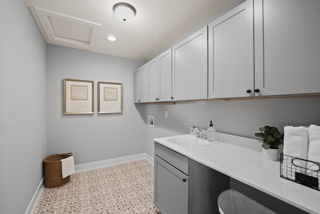 laundry room with washer hookup, cabinets, and sink