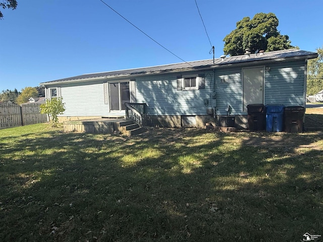 back of house featuring a lawn