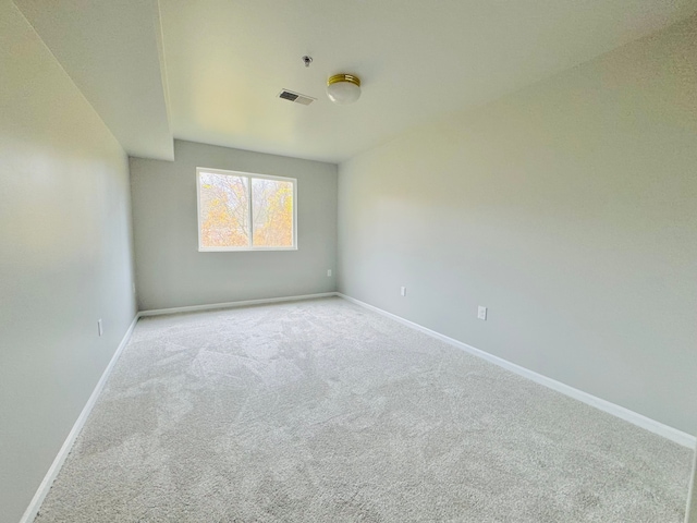 unfurnished room with light carpet