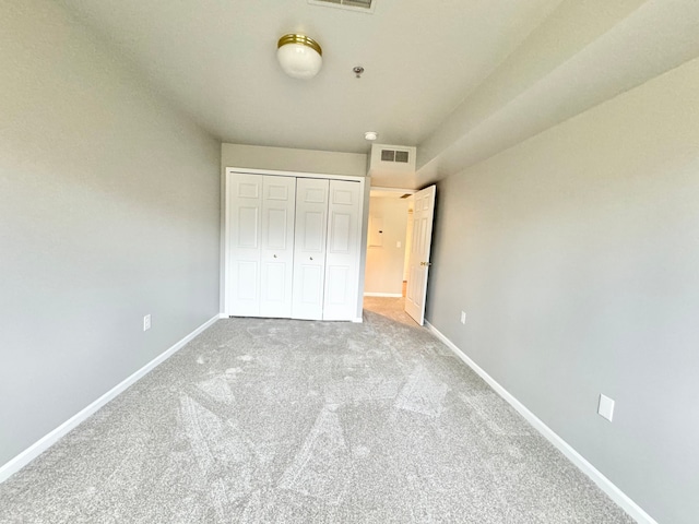 unfurnished bedroom with a closet and carpet