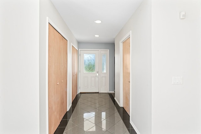 hallway with dark tile patterned flooring