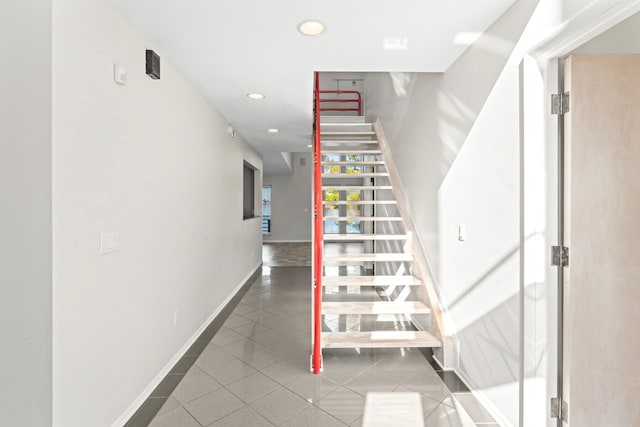 staircase featuring tile patterned flooring