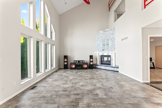 living room with hardwood / wood-style floors, a wealth of natural light, and high vaulted ceiling