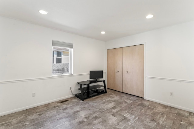 unfurnished bedroom featuring light wood-type flooring and a closet