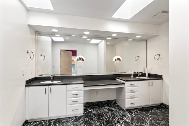 bathroom with vanity and a skylight