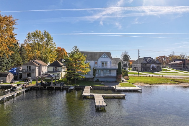 exterior space with a gazebo, a water view, and a lawn