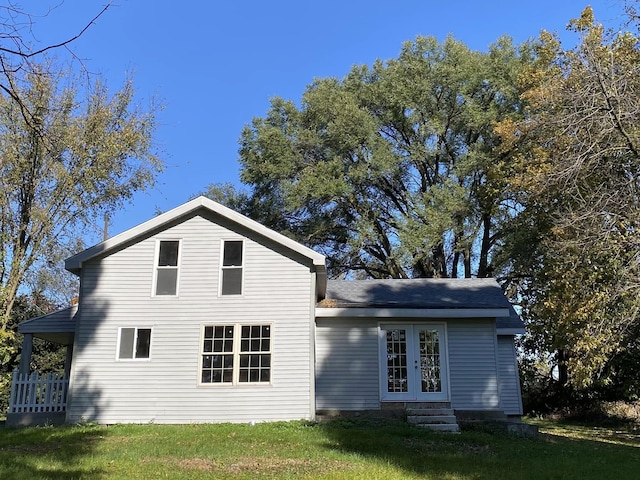 rear view of house with a yard and french doors