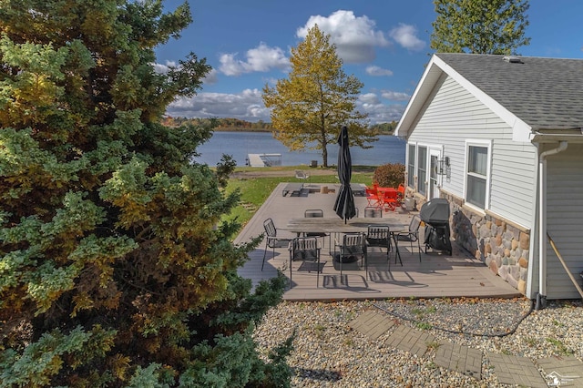 view of patio / terrace with area for grilling and a deck with water view