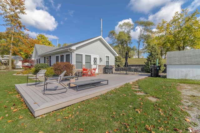 back of house featuring a yard and a deck