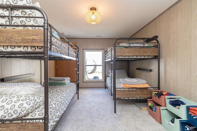 bedroom featuring carpet and wood walls