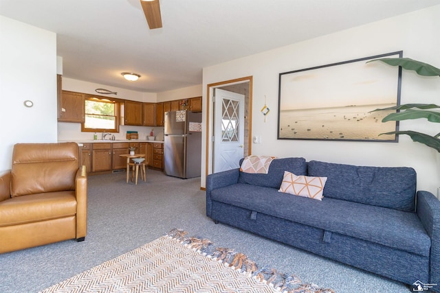 carpeted living room featuring sink