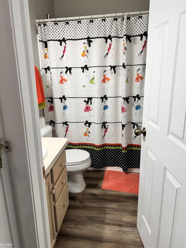 bathroom with vanity, hardwood / wood-style flooring, a shower with curtain, and toilet