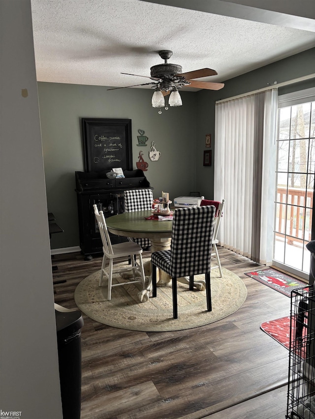 dining room with hardwood / wood-style flooring, ceiling fan, and a textured ceiling