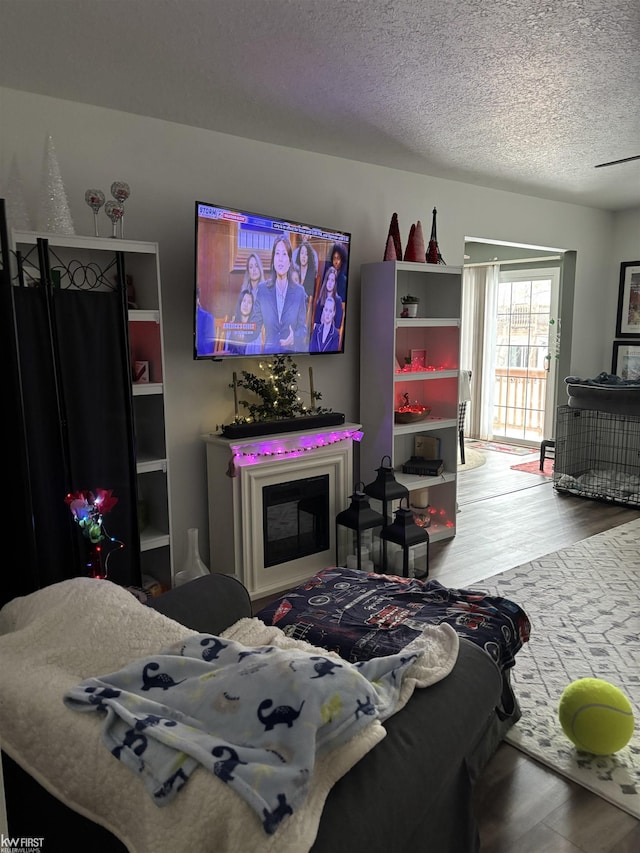 bedroom with hardwood / wood-style flooring and a textured ceiling