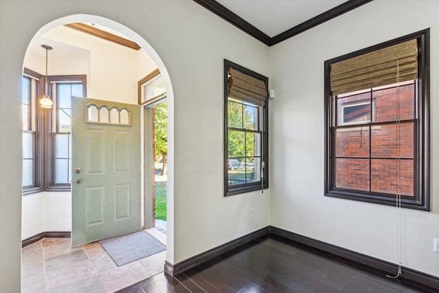 foyer entrance with wood-type flooring and crown molding