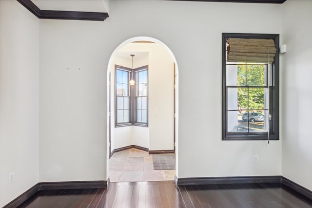 unfurnished room with hardwood / wood-style floors and ornamental molding