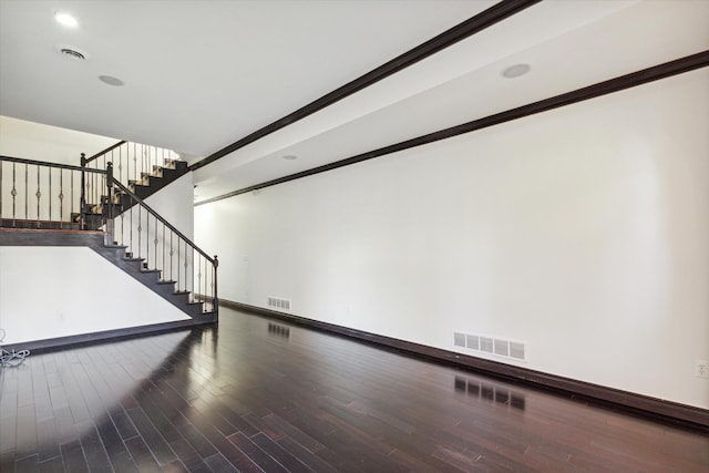 unfurnished living room with crown molding and hardwood / wood-style flooring