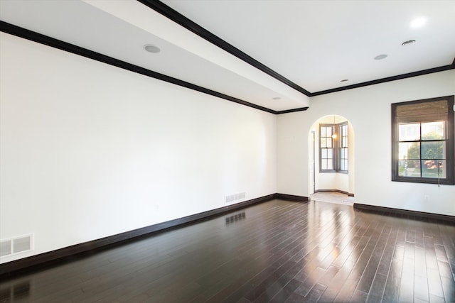 empty room with dark hardwood / wood-style floors and ornamental molding