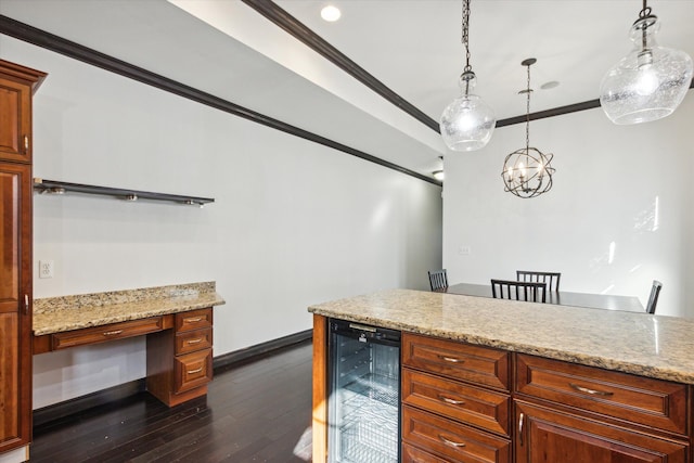 kitchen with light stone countertops, hanging light fixtures, beverage cooler, dark hardwood / wood-style flooring, and ornamental molding