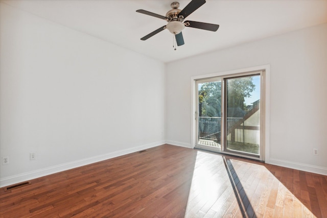 empty room featuring ceiling fan and dark wood-type flooring