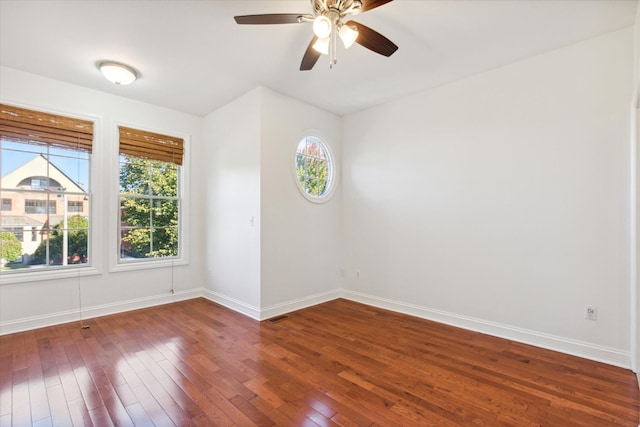 spare room featuring dark hardwood / wood-style flooring and ceiling fan