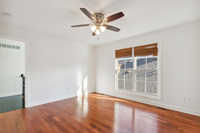 spare room featuring hardwood / wood-style flooring and ceiling fan