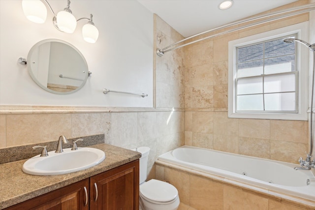 full bathroom featuring vanity, toilet, tile walls, and tiled shower / bath