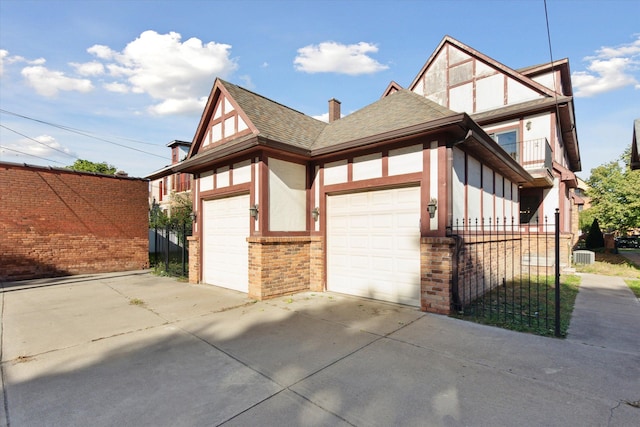 view of side of property with a balcony and a garage