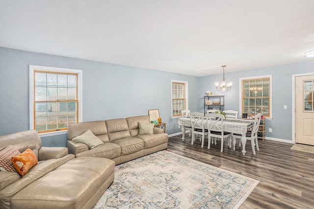 living room with hardwood / wood-style flooring and an inviting chandelier