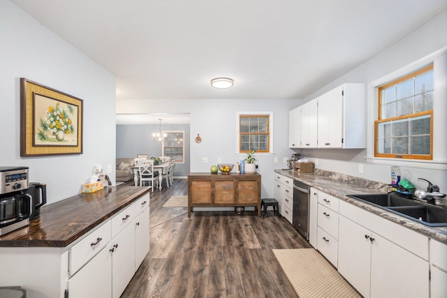 kitchen featuring dishwasher, sink, an inviting chandelier, dark hardwood / wood-style flooring, and white cabinets