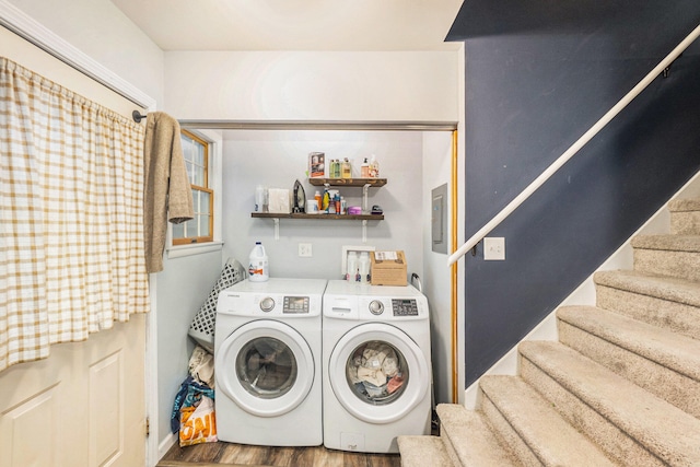 laundry room with hardwood / wood-style floors and washer and dryer