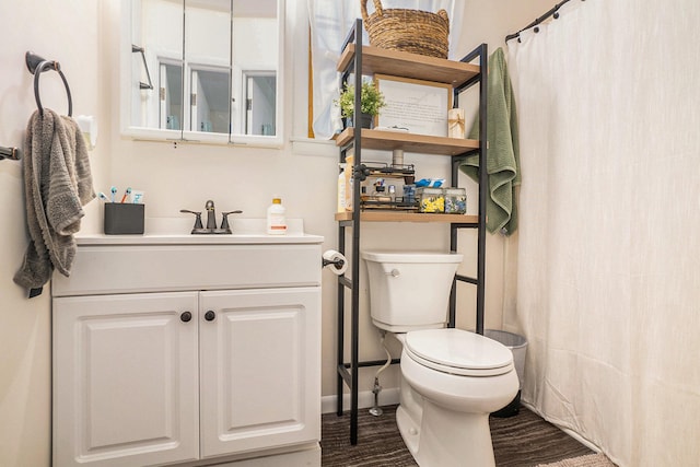 bathroom featuring vanity and toilet