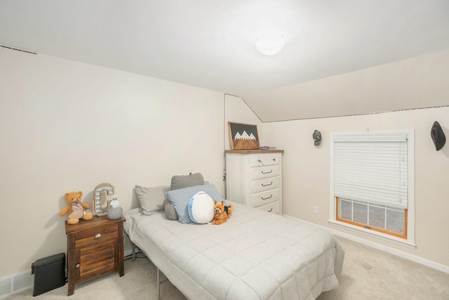 bedroom with light carpet and vaulted ceiling