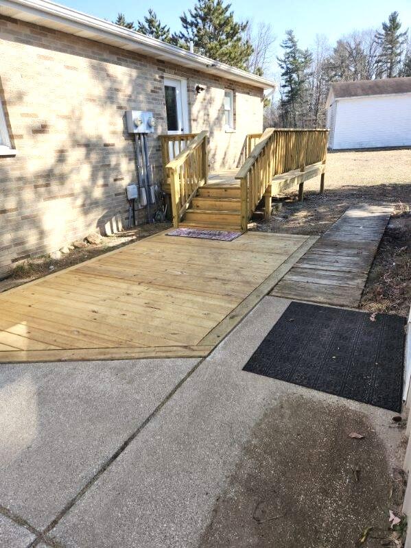 wooden terrace with a garage and an outdoor structure