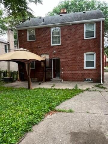 rear view of property with a yard and a patio