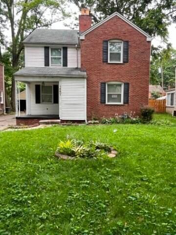 rear view of house with a lawn