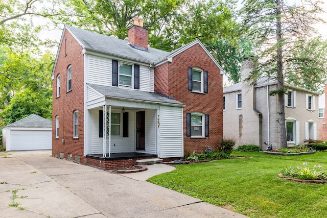 view of front of home featuring an outbuilding, a garage, covered porch, and a front yard