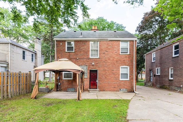 rear view of house featuring a gazebo, a yard, and a patio