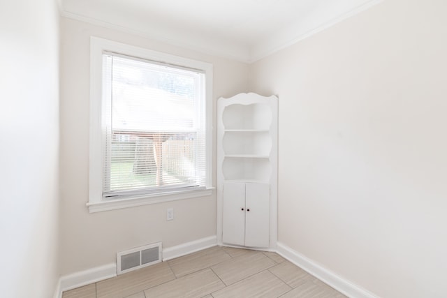 empty room featuring ornamental molding