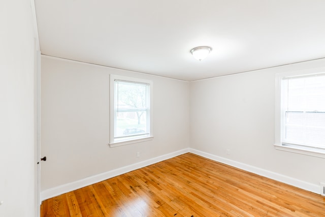 spare room with hardwood / wood-style floors