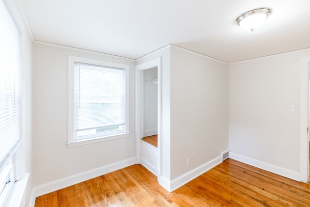 additional living space with light hardwood / wood-style floors