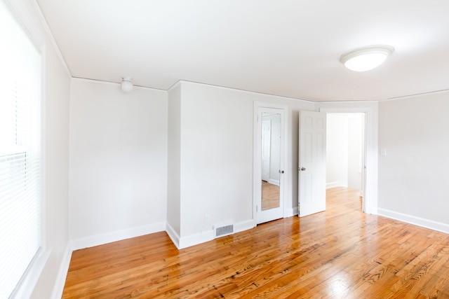 empty room with hardwood / wood-style flooring