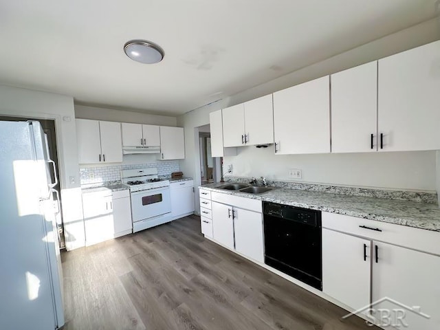 kitchen with white appliances, dark wood-type flooring, sink, tasteful backsplash, and white cabinetry