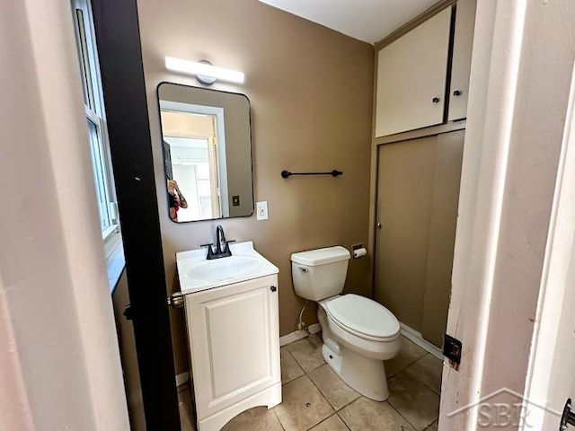 bathroom featuring tile patterned flooring, vanity, and toilet